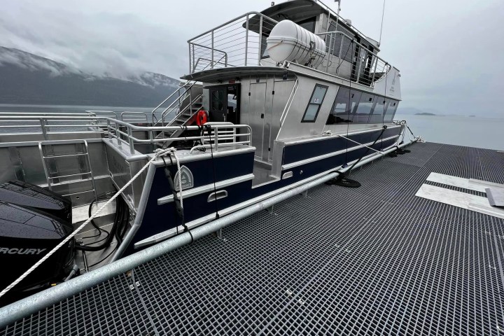 a boat that is sitting on a dock next to a body of water