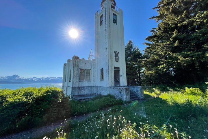 a tall clock tower sitting next to a body of water